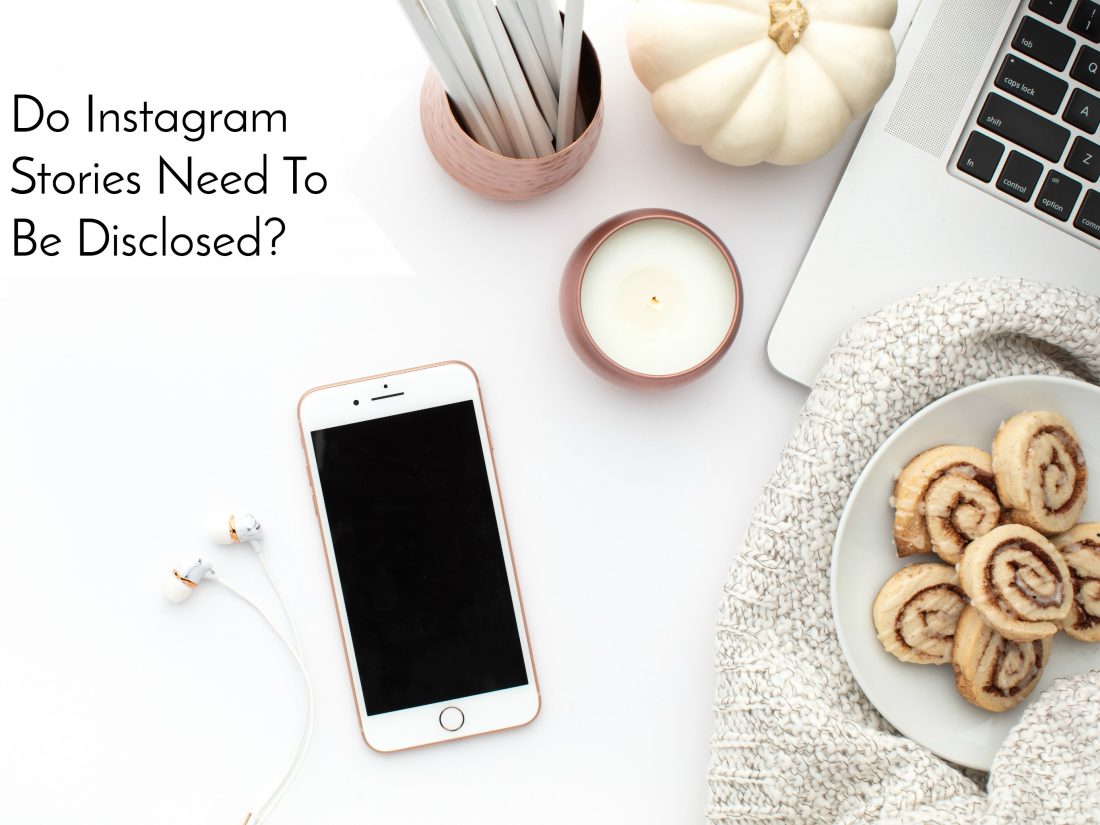 Do Instagram Stories Need To Be Disclosed? - Header Image Contains iPhone, Laptop, Cinnamon Rolls, Desk Items and a Pumpkin